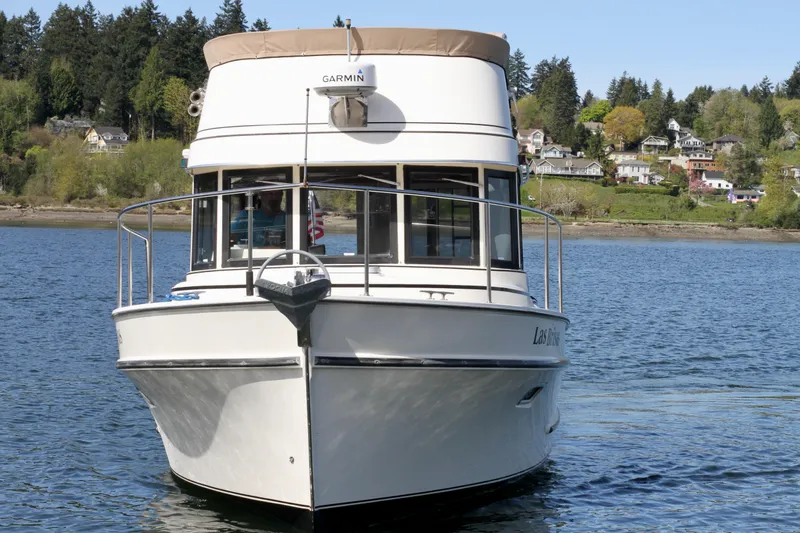 Slide: The Image of 1995 Camano Troll boat on a serene lake with scenic background. - 5