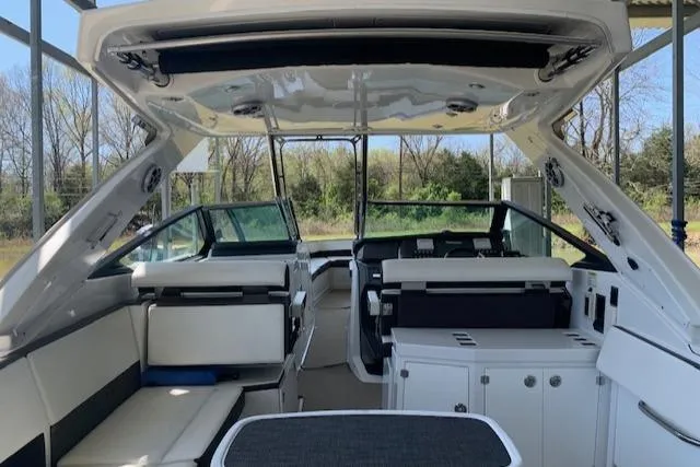 Slide: The Image of 2017 Monterey 378 SE boat interior with seating and cabinetry under a canopy. - 12