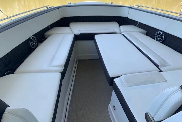 Slide: The Image of 2017 Monterey 378 SE boat interior with white cushioned seating and table. - 14