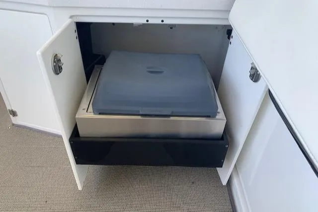 Slide: The Image of Open cabinet with storage compartment on a 2017 Monterey 378 SE boat. - 27