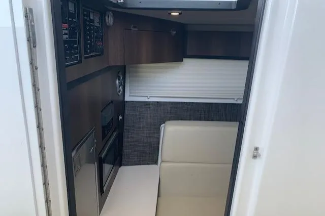 Slide: The Image of Interior of 2017 Monterey 378 SE boat, featuring modern cabinetry and seating. - 34