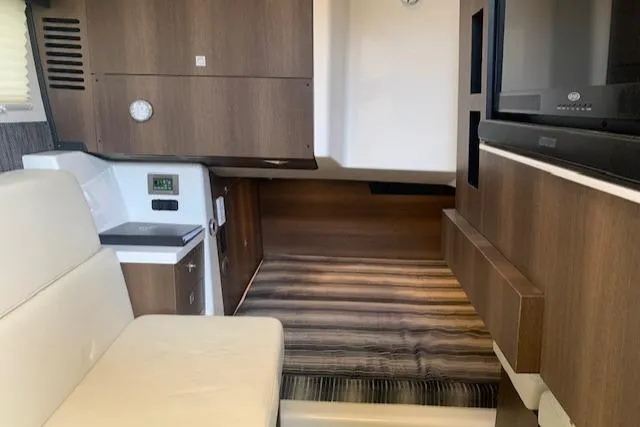 Slide: The Image of Interior of a 2017 Monterey 378 SE boat with modern wood finish and seating. - 37