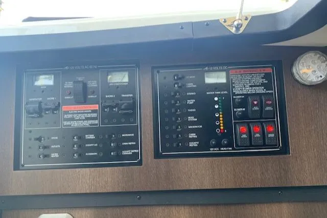 Slide: The Image of Control panel of a 2017 Monterey 378 SE boat with various switches and gauges. - 40