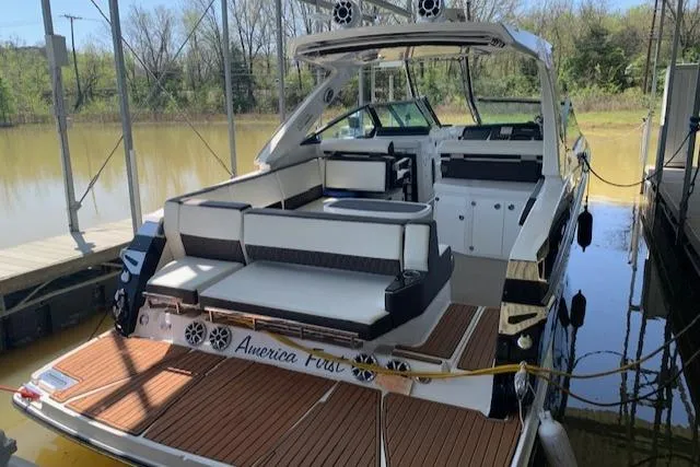 Slide: The Image of 2017 Monterey 378 SE boat docked, featuring spacious seating and sleek design. - 7