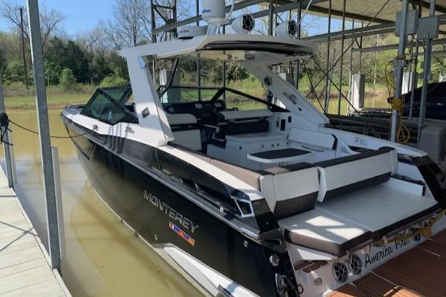 Slide: The Image of 2017 Monterey 378 SE boat docked in a marina, featuring sleek design and spacious seating. - 8