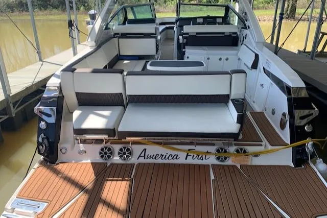 Slide: The Image of 2017 Monterey 378 SE boat with spacious seating and teak deck, docked by the water. - 9