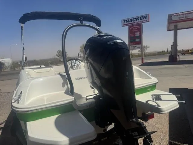 Slide: The Image of Bayliner Element E18 boat, 2003 model, with outboard motor in a parking lot. - 2