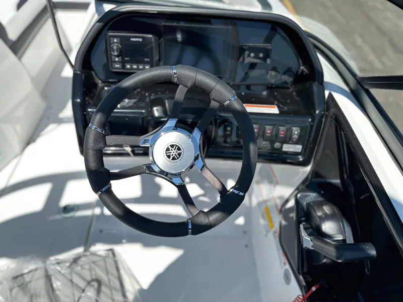 Slide: The Image of Steering wheel and dashboard of 2025 Yamaha Boats 195S, showcasing modern controls and design. - 16