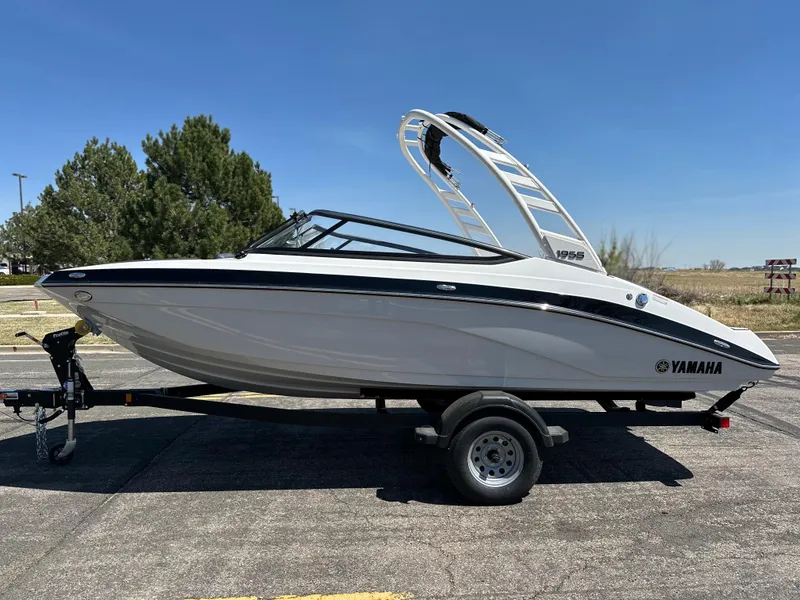 Slide: The Image of 2025 Yamaha Boats 195S on trailer, sleek design, parked outdoors. - 18