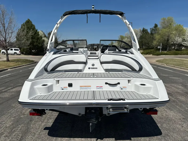 Slide: The Image of 2025 Yamaha Boats 195S, rear view, parked on a sunny day, showcasing sleek design. - 3