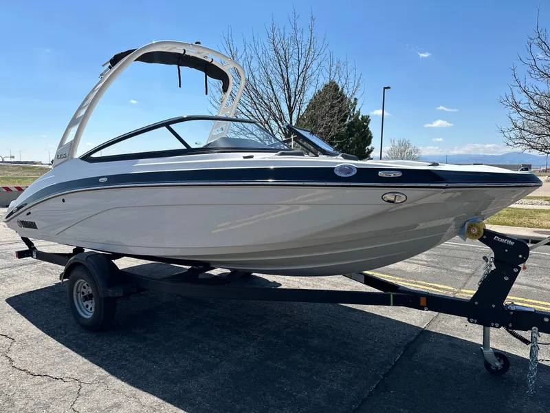 Slide: The Image of 2025 Yamaha Boats 195S on trailer, sleek design, parked outdoors under clear sky. - 6