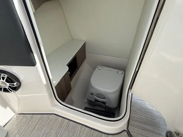 Slide: The Image of 2020 Regal LS6 Surf boat interior with white seating and sleek dashboard design. - 12