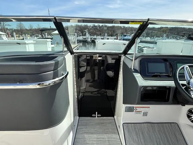 Slide: The Image of 2020 Regal LS6 Surf boat interior with compact toilet and storage area. - 13