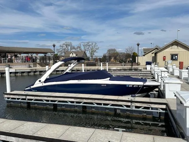 Slide: The Image of 2020 Regal LS6 Surf boat docked with cover at marina. - 2
