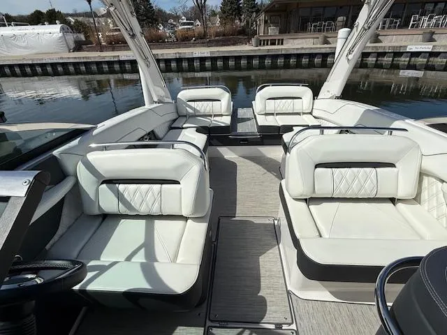 Slide: The Image of 2020 Regal LS6 Surf boat storage compartment with open lid, showcasing interior space. - 20