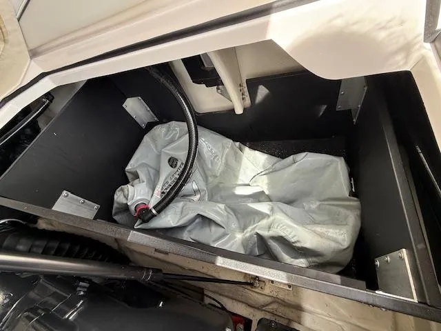 Slide: The Image of 2020 Regal LS6 Surf engine compartment with visible components and fire extinguisher. - 24