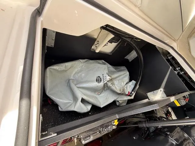 Slide: The Image of Storage compartment of a 2020 Regal LS6 Surf boat, featuring a covered item inside. - 25