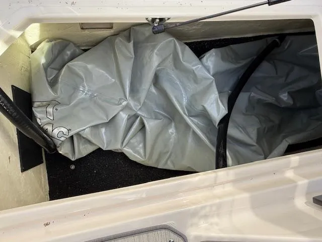 Slide: The Image of 2020 Regal LS6 Surf storage compartment with covered equipment and wiring. - 26