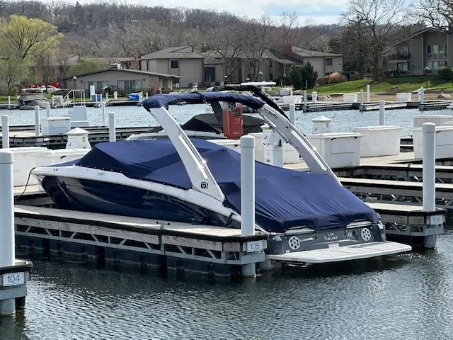 Slide: The Image of 2020 Regal LS6 Surf boat docked at a marina under a clear sky. - 3