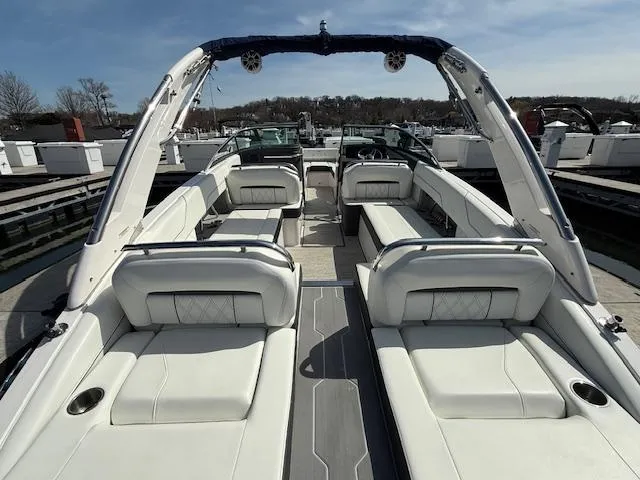 Slide: The Image of 2020 Regal LS6 Surf boat docked with cover in a marina setting. - 4