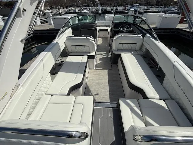 Slide: The Image of 2020 Regal LS6 Surf boat with spacious seating and sleek design at a marina. - 5