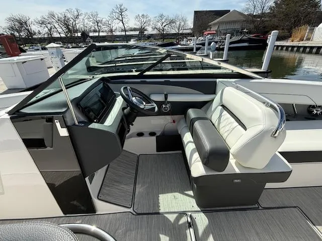 Slide: The Image of 2020 Regal LS6 Surf boat interior with adjustable seating and sleek design at a dock. - 7