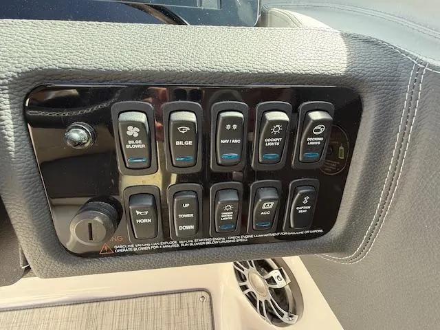 Slide: The Image of 2020 Regal LS6 Surf boat dashboard with sleek steering wheel and modern controls. - 9