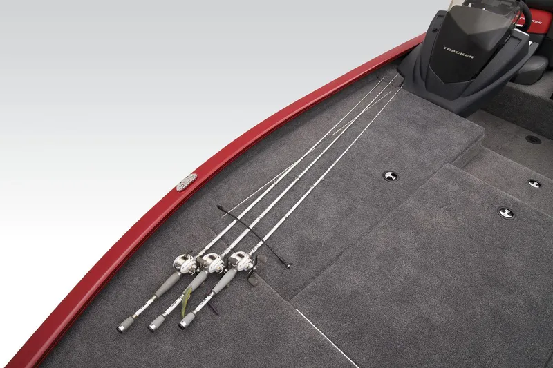 Slide: The Image of 2025 Tracker Savage 215 boat interior with fishing rods on carpeted deck. - 29