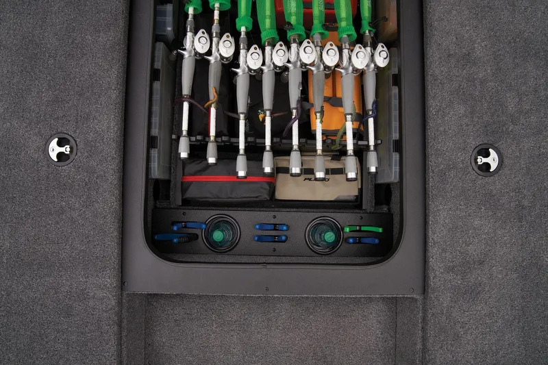 Slide: The Image of Fishing rod storage compartment in 2025 Tracker Savage 215 boat, featuring organized rod holders. - 34