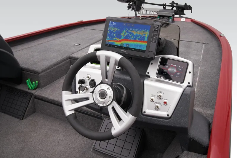 Slide: The Image of 2025 Tracker Savage 215 boat dashboard with steering wheel and advanced navigation display. - 42