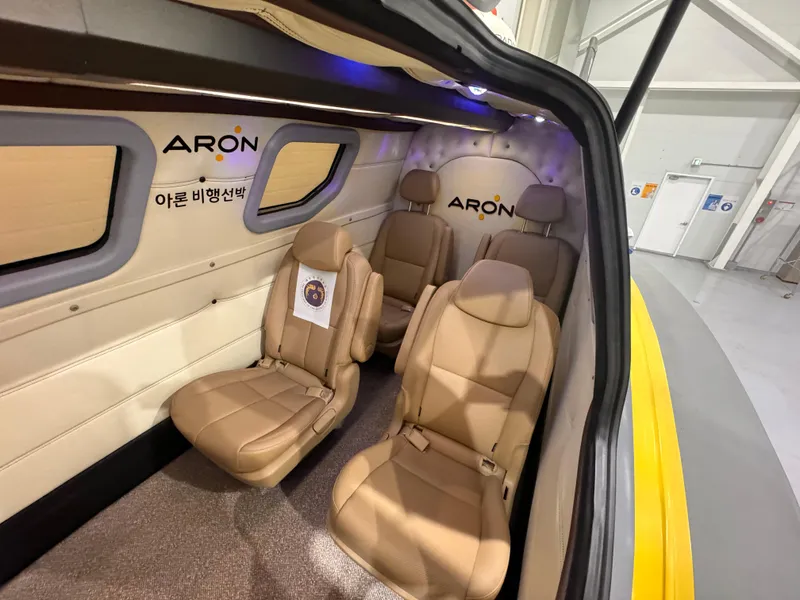 Slide: The Image of Interior of Aron M 80, 2025 model, featuring luxurious beige leather seats. - 11