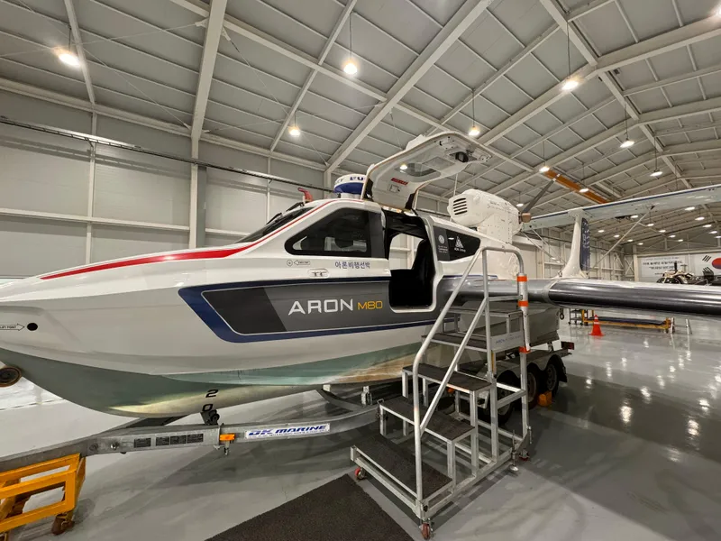 Slide: The Image of Futuristic Aron M 80 seaplane, 2025 model, with sleek design and red accents. - 14