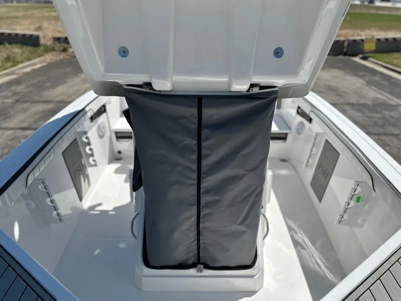Slide: The Image of 2025 Yamaha Boats 222 FSH Sport interior with open storage compartment. - 10