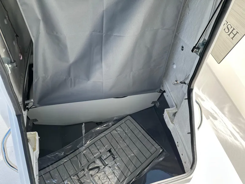 Slide: The Image of 2025 Yamaha Boats 222 FSH Sport storage compartment with protective mat. - 11