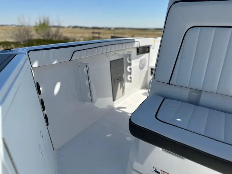 Slide: The Image of 2025 Yamaha Boats 222 FSH Sport interior with white seating and sleek design. - 13