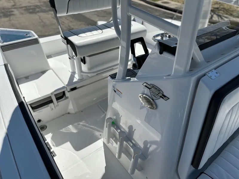 Slide: The Image of 2025 Yamaha Boats 222 FSH Sport interior, featuring sleek white seating and modern controls. - 16