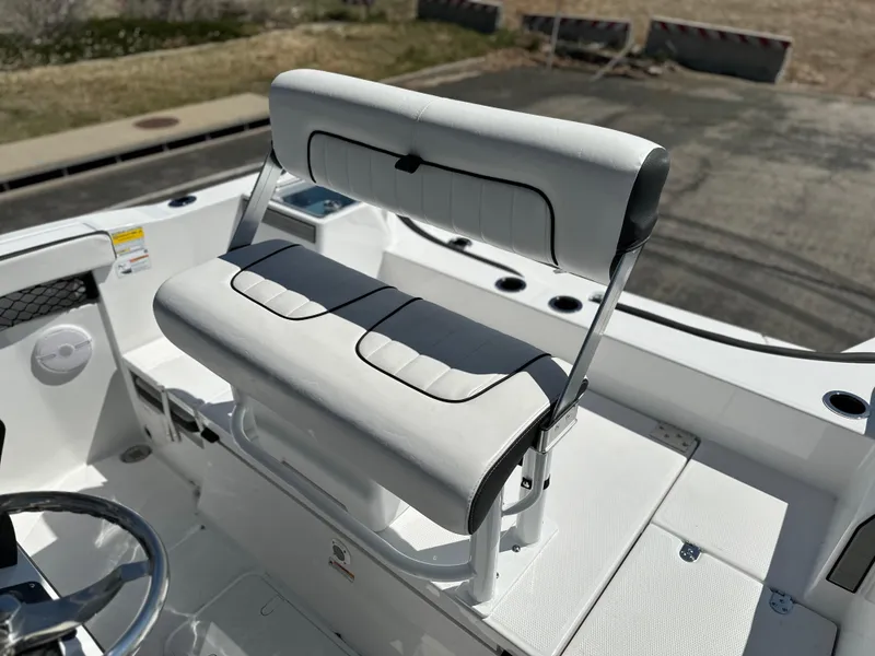 Slide: The Image of 2025 Yamaha Boats 222 FSH Sport interior with white seating and steering wheel. - 18