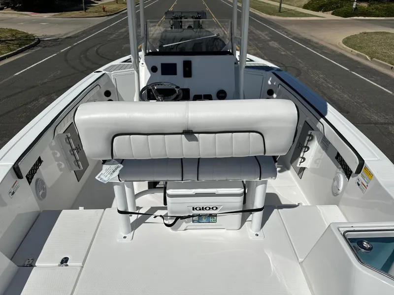 Slide: The Image of 2025 Yamaha Boats 222 FSH Sport interior with seating and console, featuring Igloo cooler. - 22