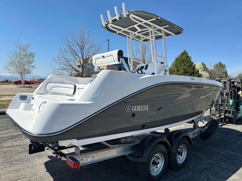 Slide: The Image of 2025 Yamaha Boats 222 FSH Sport on trailer, sleek design, outdoor setting. - 4