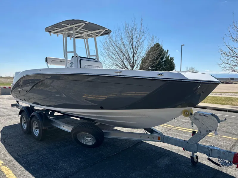 Slide: The Image of 2025 Yamaha Boats 222 FSH Sport on trailer, parked outdoors under clear sky. - 6