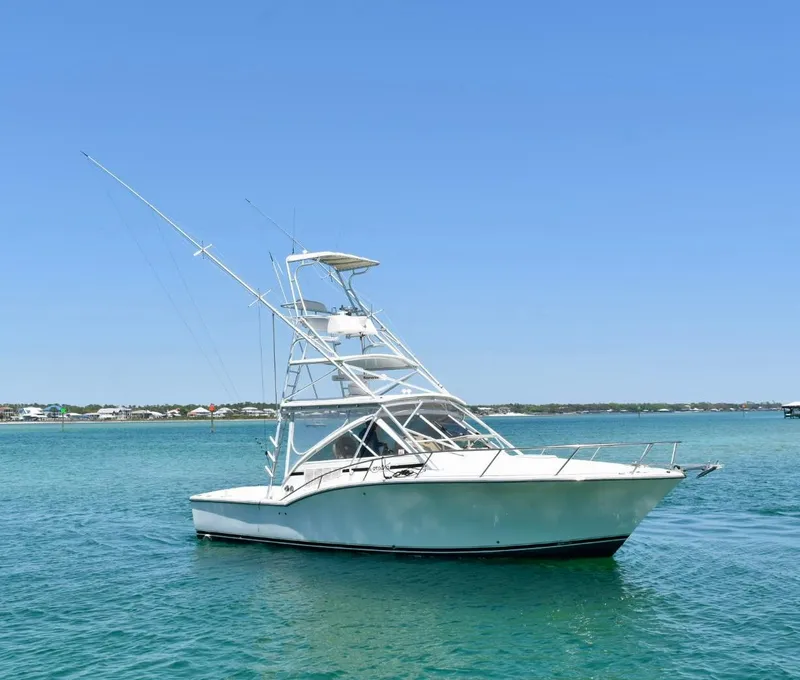 The Image of 2006 Carolina Classic 32 boat on calm blue water under clear sky. - 0