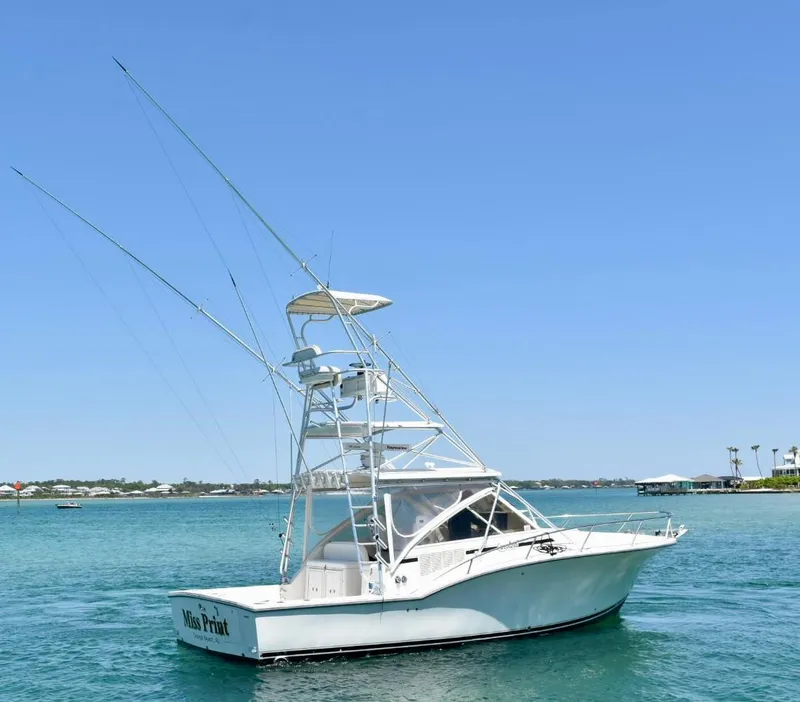 Slide: The Image of 2006 Carolina Classic 32 boat on clear blue water under a sunny sky. - 1