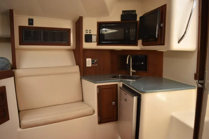 Slide: The Image of Interior of 2006 Carolina Classic 32 boat with kitchenette and seating area. - 15