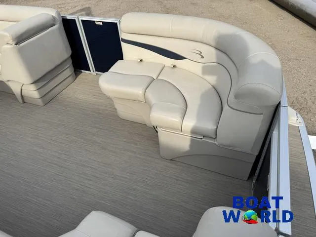 Slide: The Image of 2017 Bennington 21SSX Pontoon boat interior with beige seating and flooring. - 10
