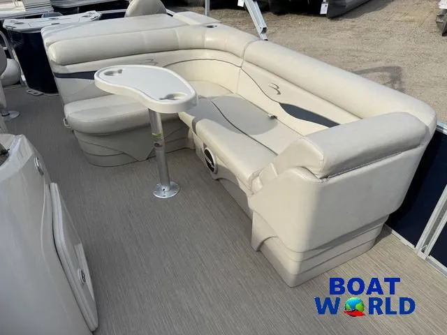 Slide: The Image of 2017 Bennington 21SSX Pontoon boat interior with beige seating and table. - 19