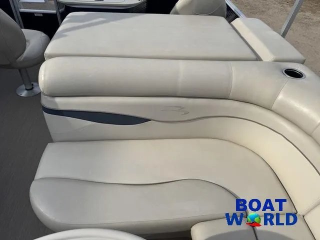 Slide: The Image of 2017 Bennington 21SSX Pontoon boat interior with beige seating and cup holder. - 24