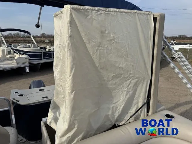 Slide: The Image of 2017 Bennington 21SSX Pontoon with covered seating area at Boat World dealership. - 28