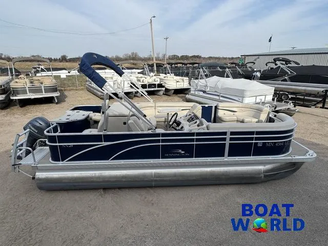 Slide: The Image of 2017 Bennington 21SSX Pontoon boat in a marina, featuring blue and silver design. - 3