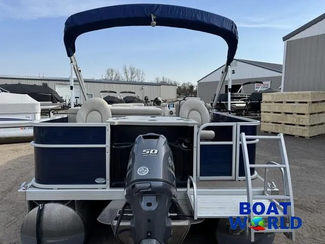 Slide: The Image of 2017 Bennington 21SSX Pontoon boat with canopy and outboard motor at a dealership. - 30
