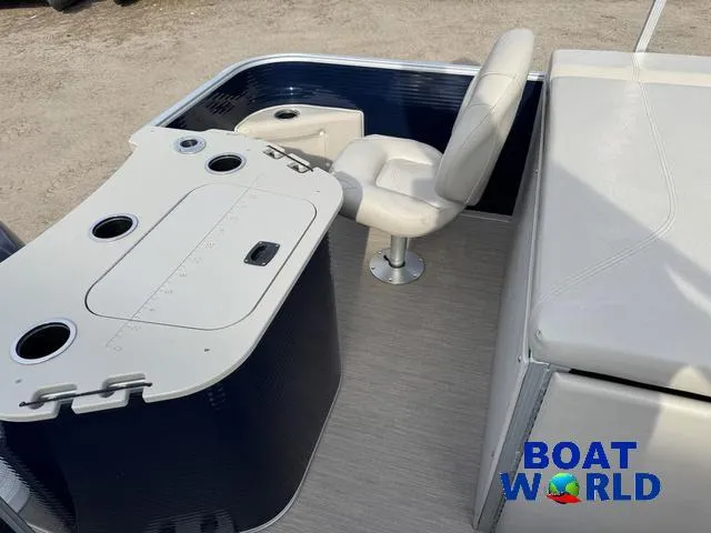 Slide: The Image of 2017 Bennington 21SSX Pontoon boat interior with seating and console, Boat World logo visible. - 32